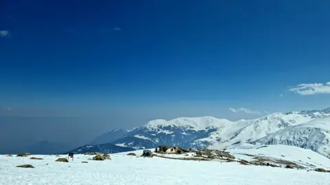 Deep snow and blue sky on the slopes above Gulmarg Deep snow and blue sky on the slopes above Gulmarg
