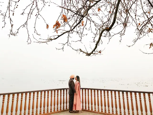 A couple on a wooden deck in misty winter Kashmir