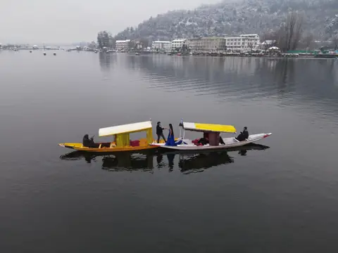 Two shikaras on a still Dal Lake in winter